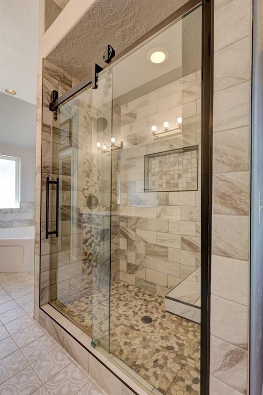 bathroom with tile patterned floors and separate shower and tub