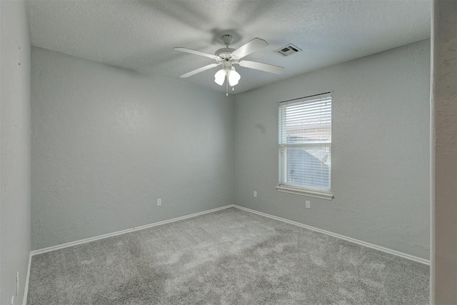 carpeted empty room featuring a textured ceiling and ceiling fan