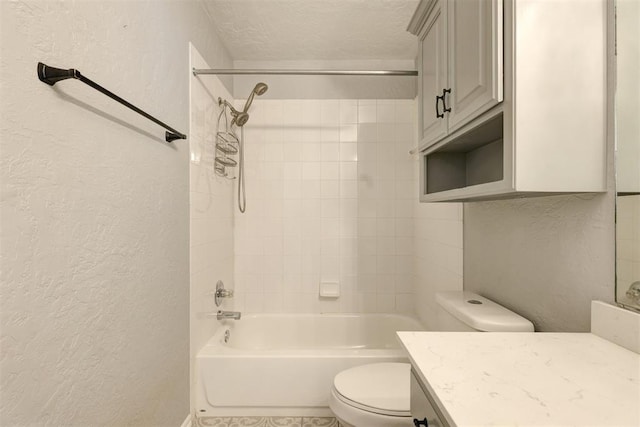 full bathroom with vanity, tiled shower / bath combo, a textured ceiling, and toilet