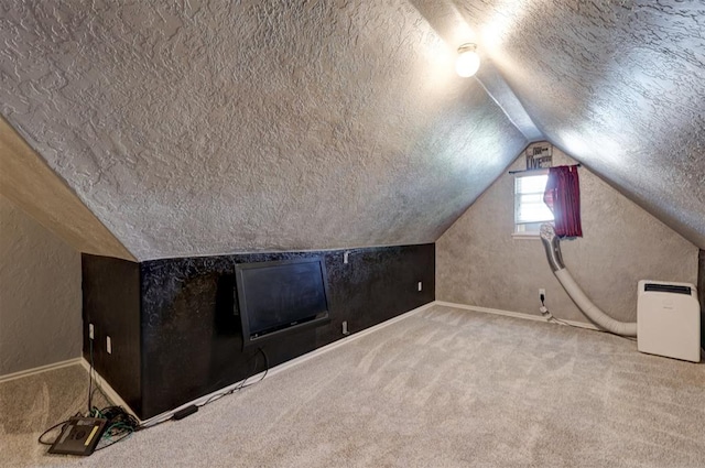 bonus room featuring vaulted ceiling, carpet floors, and a textured ceiling