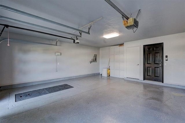 garage featuring electric panel and a garage door opener