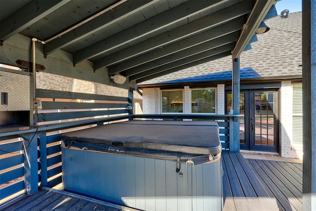 wooden deck featuring a hot tub