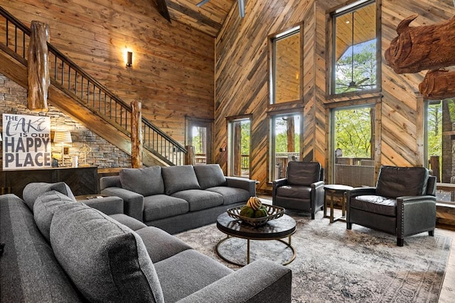 living room featuring beamed ceiling, a high ceiling, and hardwood / wood-style flooring