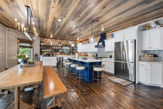 dining room featuring an inviting chandelier, dark hardwood / wood-style floors, lofted ceiling, wooden walls, and wood ceiling