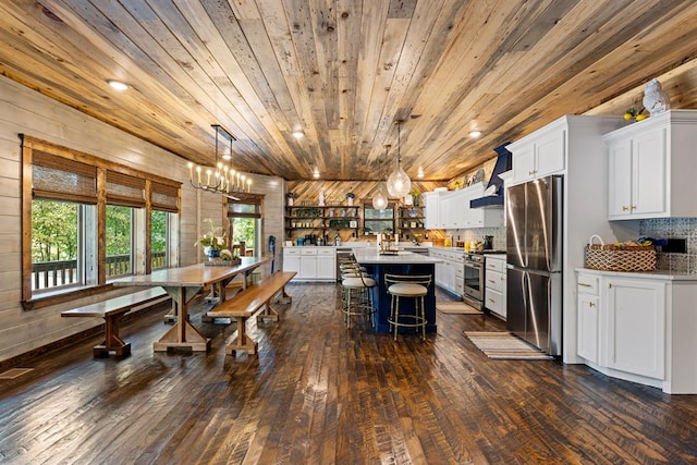 dining area featuring wood walls, dark hardwood / wood-style flooring, and wooden ceiling