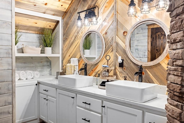 bathroom with vanity and wood walls