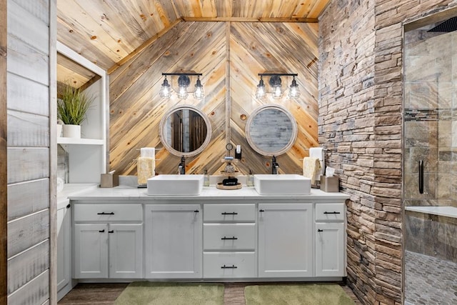 bathroom with vanity, vaulted ceiling, wooden walls, wooden ceiling, and hardwood / wood-style floors