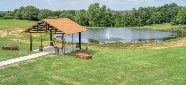 view of home's community with a lawn and a water view