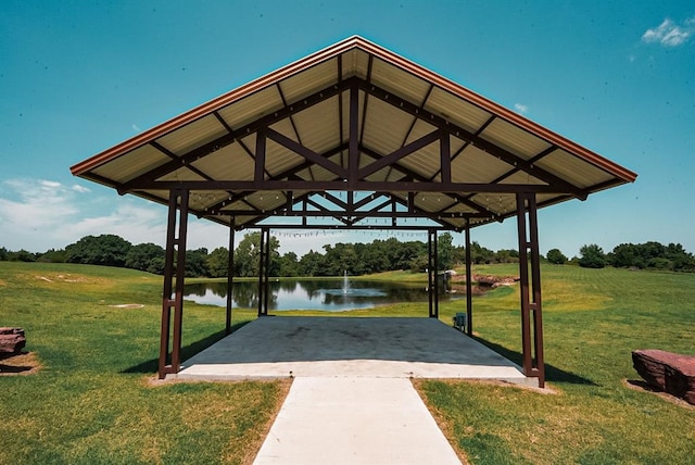 view of community with a gazebo, a yard, and a water view