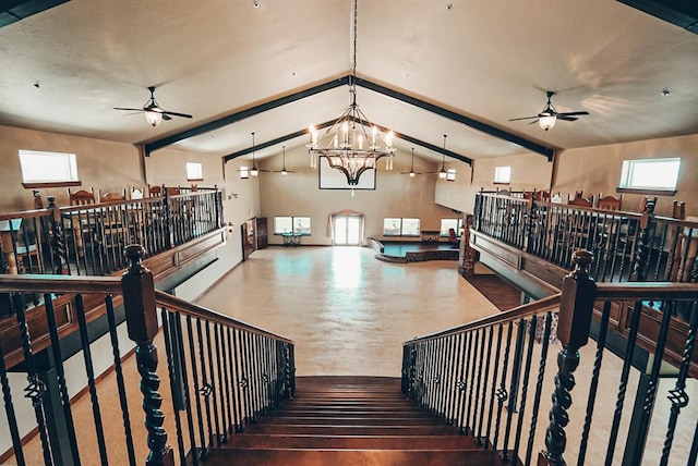stairway featuring ceiling fan with notable chandelier and vaulted ceiling with beams