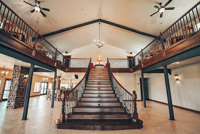 stairway featuring ceiling fan with notable chandelier and high vaulted ceiling