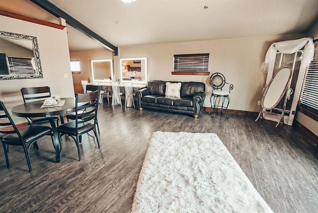 dining space featuring beam ceiling and dark hardwood / wood-style flooring