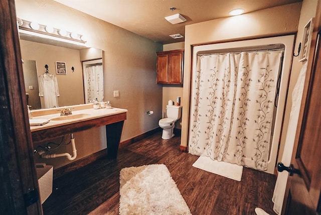 bathroom featuring hardwood / wood-style floors, toilet, and sink
