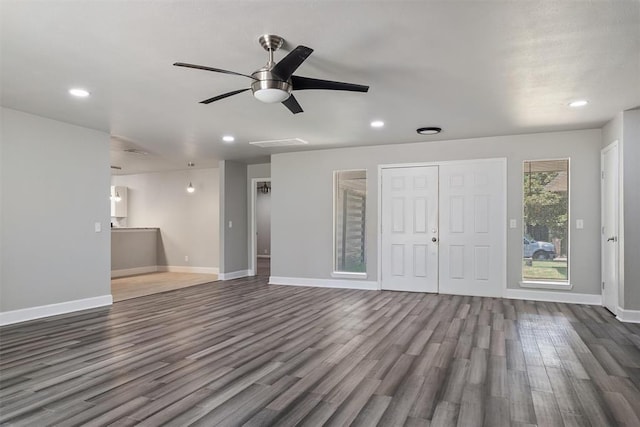 unfurnished living room with hardwood / wood-style flooring and ceiling fan