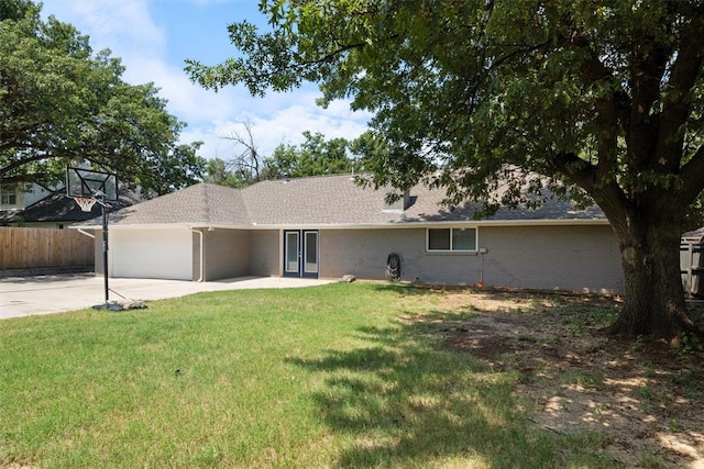 ranch-style home with a front lawn and a garage