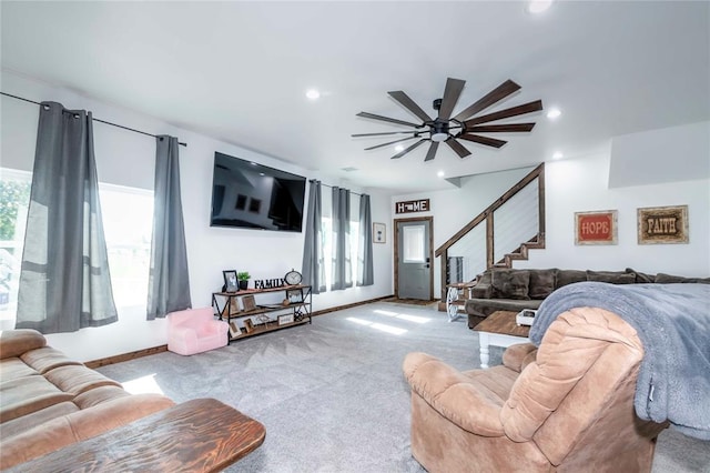 carpeted living room with ceiling fan