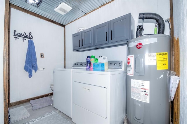 laundry area with washing machine and clothes dryer, water heater, and cabinets