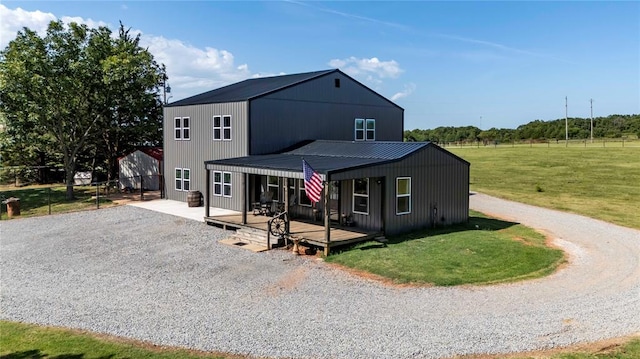 view of front of property with a wooden deck and a front lawn