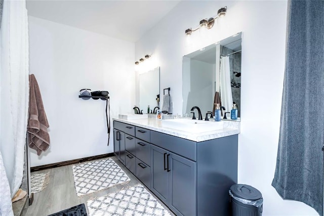 bathroom with curtained shower and vanity