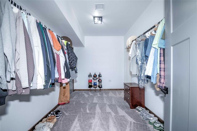 walk in closet featuring carpet flooring