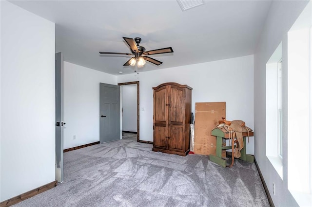 bedroom with ceiling fan and light colored carpet