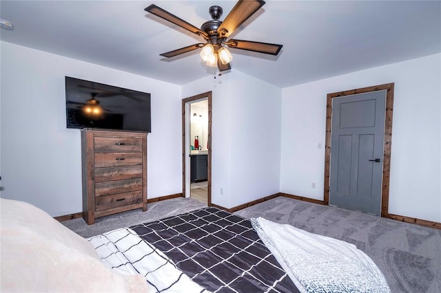 carpeted bedroom featuring connected bathroom and ceiling fan