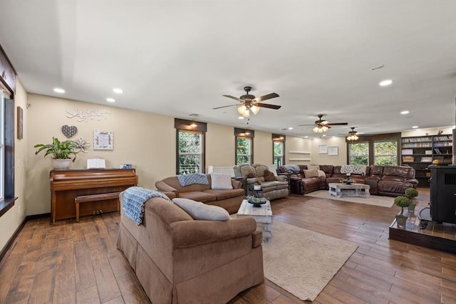 living room featuring ceiling fan, hardwood / wood-style floors, and a healthy amount of sunlight