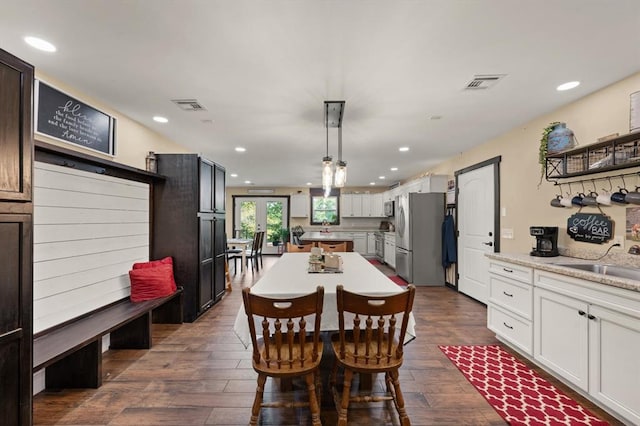 dining space featuring sink and dark hardwood / wood-style floors