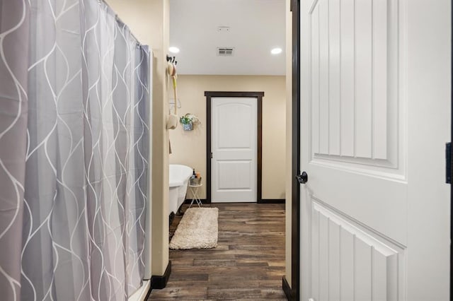 bathroom with hardwood / wood-style floors