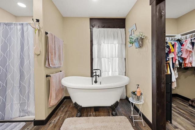 bathroom featuring independent shower and bath and wood-type flooring