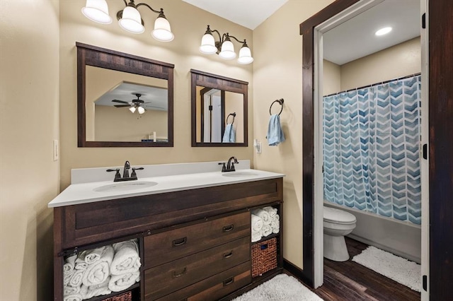 full bathroom with vanity, ceiling fan, toilet, shower / bath combo with shower curtain, and wood-type flooring