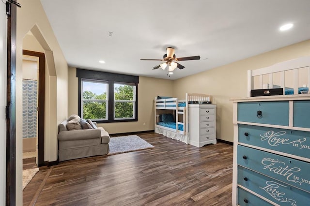 bedroom with ceiling fan and dark hardwood / wood-style flooring