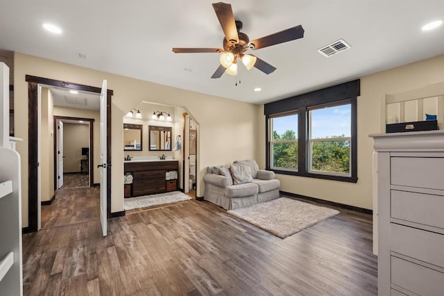 living room with ceiling fan and dark hardwood / wood-style flooring