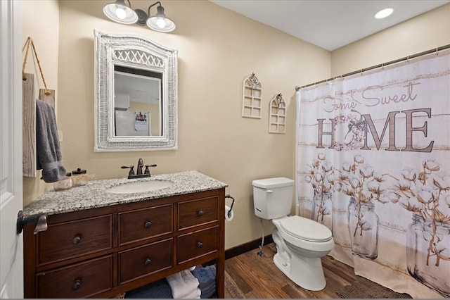 bathroom featuring hardwood / wood-style floors, vanity, and toilet