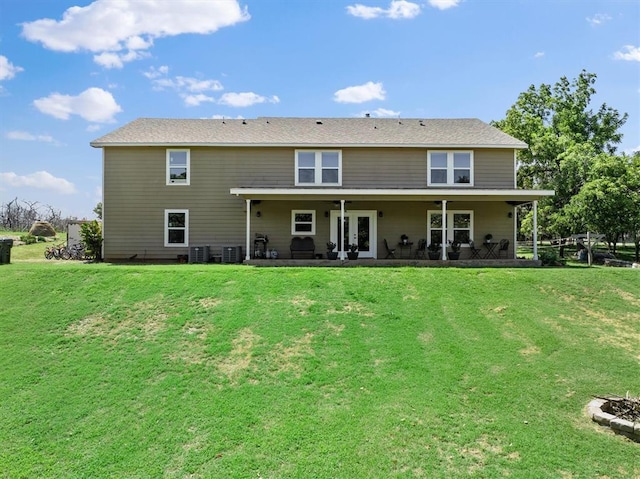 rear view of house with a lawn and a patio area