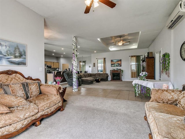 living room featuring ceiling fan, a fireplace, light carpet, and a wall mounted AC