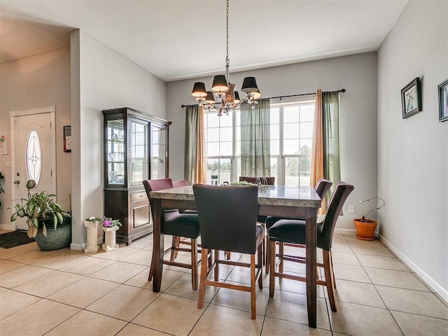 tiled dining room with plenty of natural light and an inviting chandelier