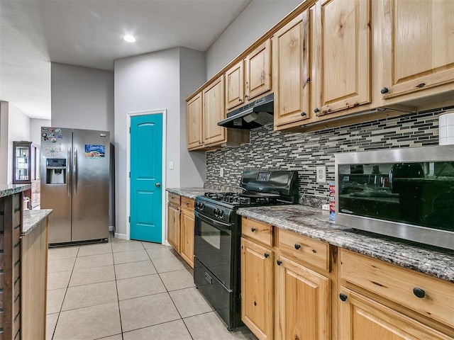 kitchen with black range with gas stovetop, light tile patterned floors, stone countertops, and stainless steel refrigerator with ice dispenser