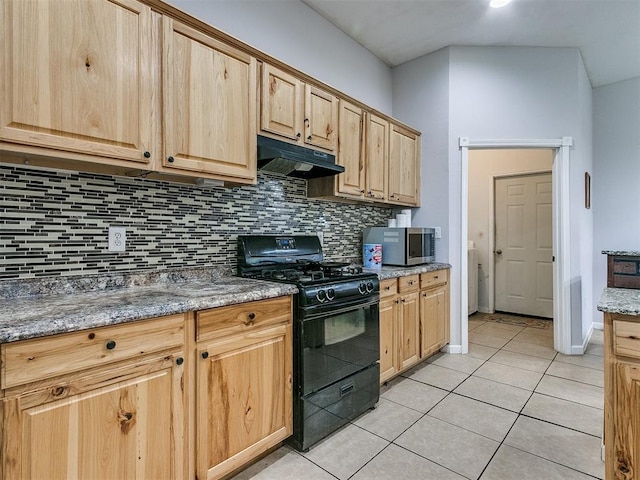 kitchen featuring tasteful backsplash, light stone counters, black gas stove, light brown cabinetry, and light tile patterned floors