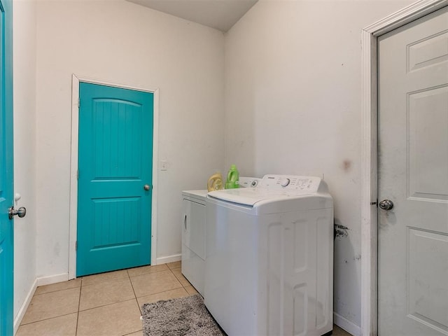 laundry area featuring light tile patterned floors and separate washer and dryer