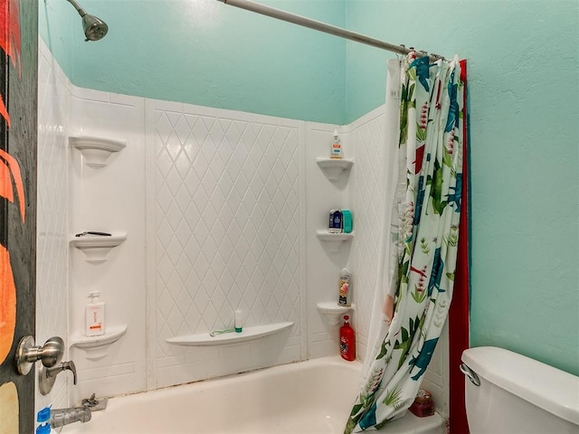 bathroom featuring shower / bath combo and toilet