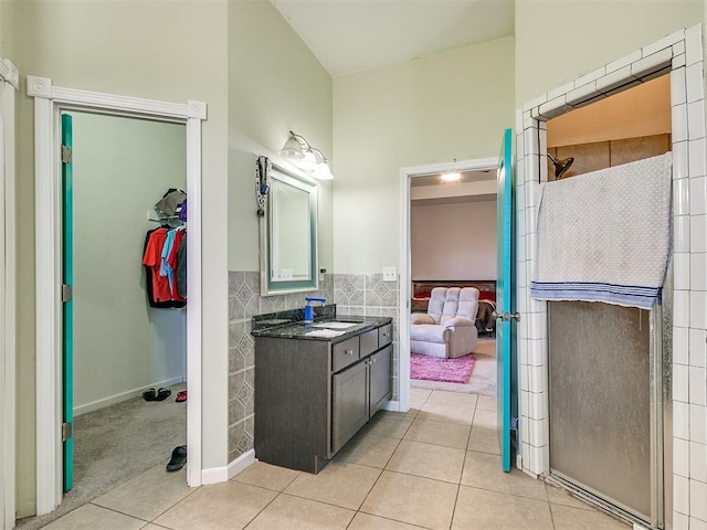 bathroom featuring tile patterned flooring, vanity, and walk in shower