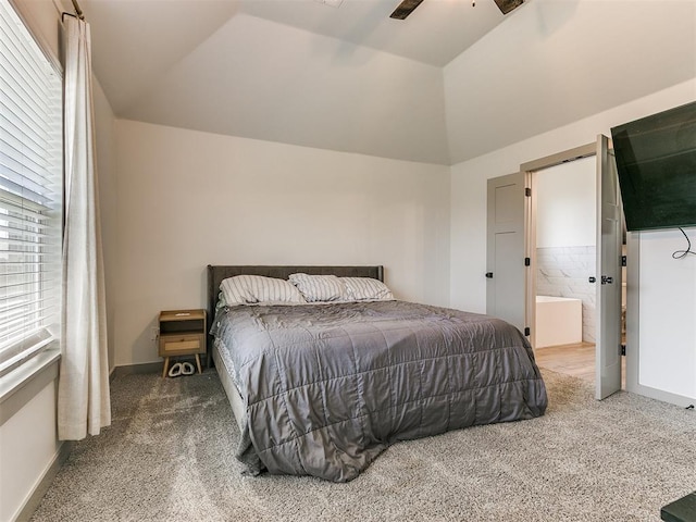 bedroom with carpet, ceiling fan, lofted ceiling, and ensuite bath