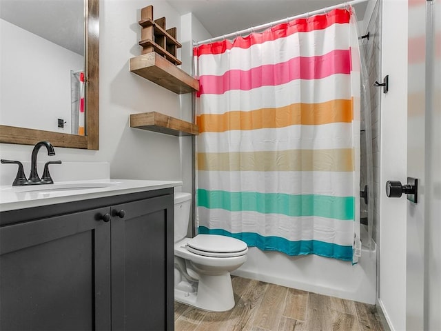 full bathroom featuring shower / bath combination with curtain, vanity, wood-type flooring, and toilet