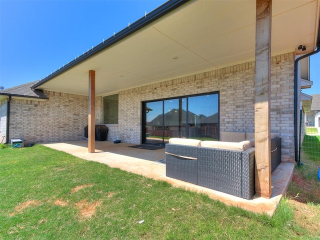 back of property with a lawn, a patio area, and outdoor lounge area