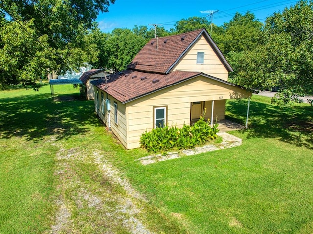 rear view of property featuring a lawn