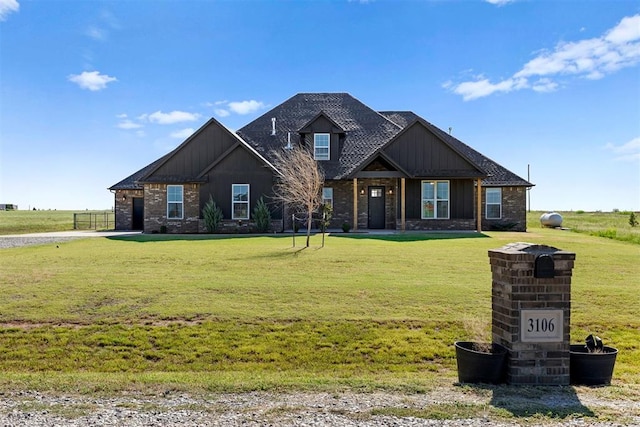 craftsman inspired home featuring brick siding, board and batten siding, and a front lawn