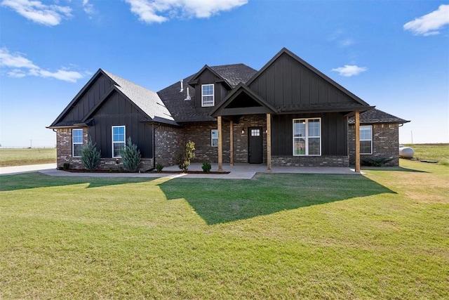 craftsman-style house featuring a front yard, brick siding, and board and batten siding