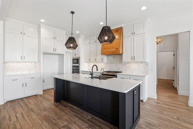 kitchen with white cabinetry, light countertops, appliances with stainless steel finishes, and a sink