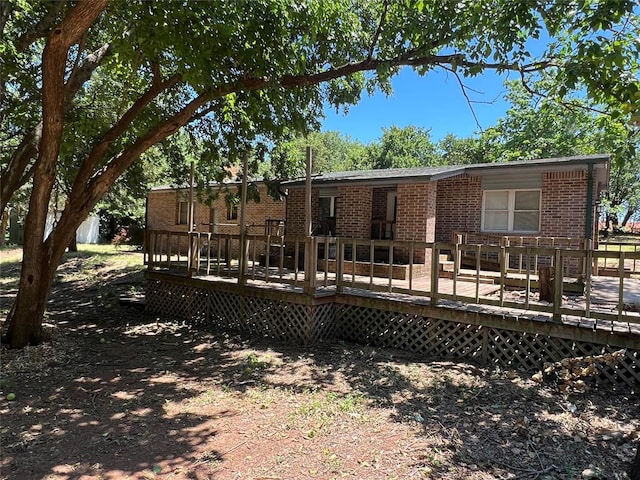 rear view of house featuring a deck